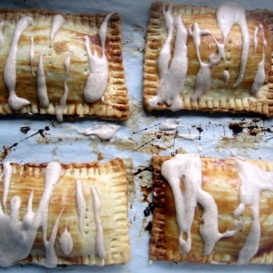 four homemade pumpkin cream cheese pop tarts with frosting