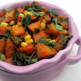 roasted spanish potatoes in a bowl with corn and kale