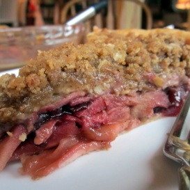 slice of deep dish bourbon apple cherry pie on a plate