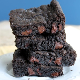 sea salt and double dark chocolate brownie cookie bars stacked on a plate