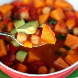Cozy vegan tomato chickpea soup with hearty sweet potatoes and incredible spices like garlic, cumin, and fresh basil. Top this nourishing soup with avocado for a delicious, filling lunch or dinner.