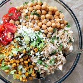 Easy healthy chicken chickpea chopped salad loaded with protein and fresh ingredients like grilled corn, grape tomatoes, crunchy romaine, creamy avocado, and your favorite dressing.