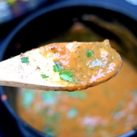 Homemade roasted green chile sauce on a spoon
