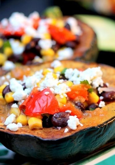 Vegetarian stuffed acorn squash with black beans, corn, red pepper and goat cheese