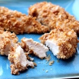 Baked honey cornflake chicken strips on a plate