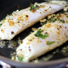Lemon garlic tilapia in a frying pan