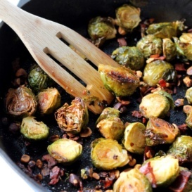 Maple roasted brussels sprouts with bacon in a skillet