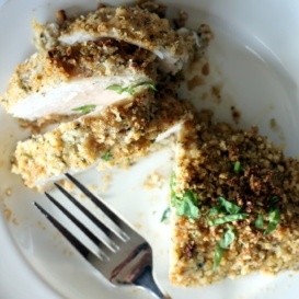 crusted chicken breast cut on plate