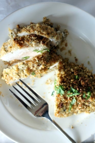 crusted chicken breast cut on plate