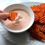 spicing dipping sauce with sweet potato fries
