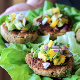 chickpea lentil burger with mango and avocado on plate with lettuce