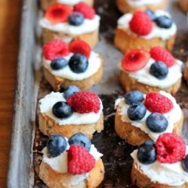 crostini with ricotta and berries on pan