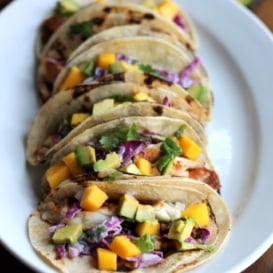 fish tacos on plate with mango and avocado
