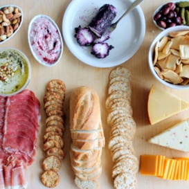 meats, cheese, and crackers on serving board