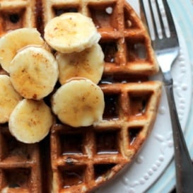 Banana chocolate chip quinoa flour waffles with sliced bananas on top