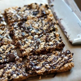 Dark chocolate cherry protein granola bars on parchment paper