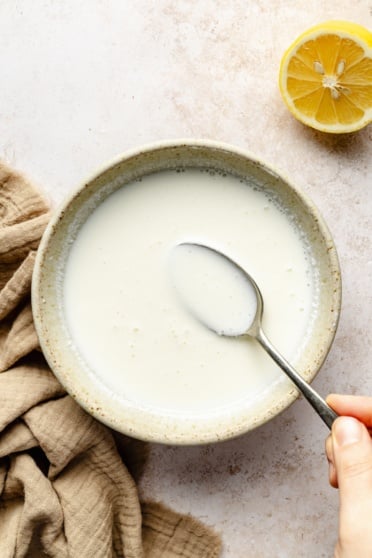 homemade buttermilk in a bowl with a spoon