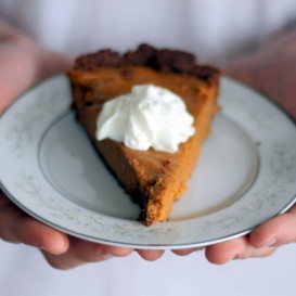 Lightened up sweet potato pie with whipped cream on a plate