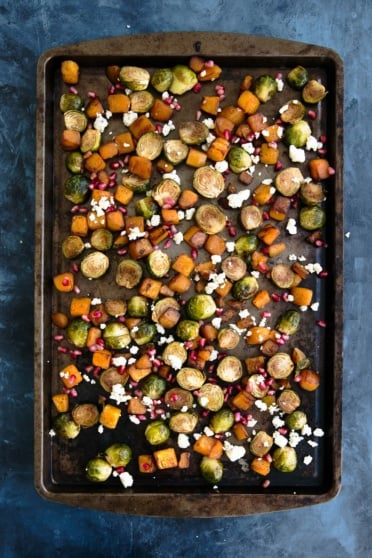 roasted butternut squash and brussels sprouts on a baking sheet