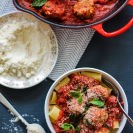 Turkey parmesan meatballs over rigatoni in a bowl