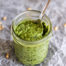 avocado basil pesto in a jar with a spoon