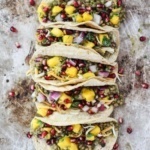lentil tacos with mango, pomegranate, onion, and cilantro