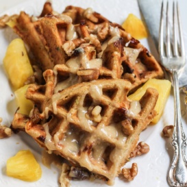 carrot cake waffles on plate with maple glaze