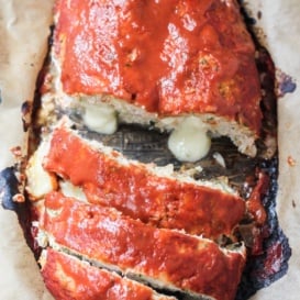 turkey zucchini meat loaf stuffed with cheese and topped with red sauce