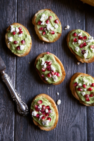 avocado crostini with feta and pomegranate seeds