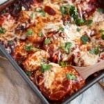 pan of sweet potato polenta bake with cheese and red chile sauce