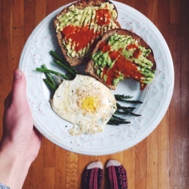 avocado toast with eggs and asparagus on a plate