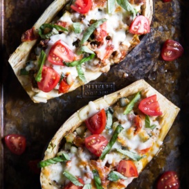 stuffed eggplant boats on a baking sheet