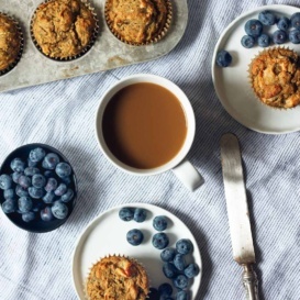paleo zucchini banana muffins on two plates and in a muffin tin