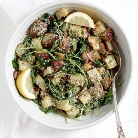 Roasted Garlic Basil Pesto Potatoes with Arugula in a bowl