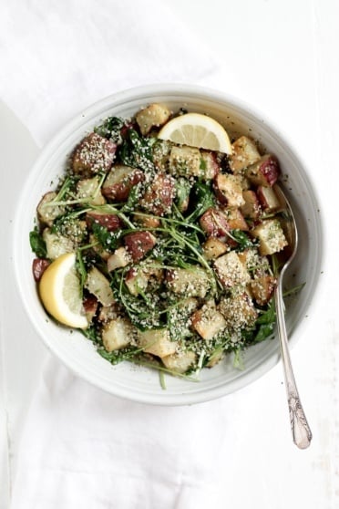 Roasted Garlic Basil Pesto Potatoes with Arugula in a bowl