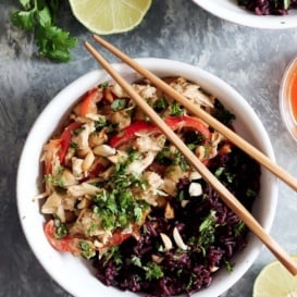 slow cooker thai peanut chicken in a bowl with chopsticks