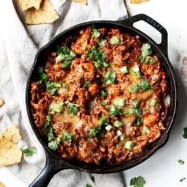 Sweet Potato & Turkey Enchilada Skillet on a linen next to tortilla chips