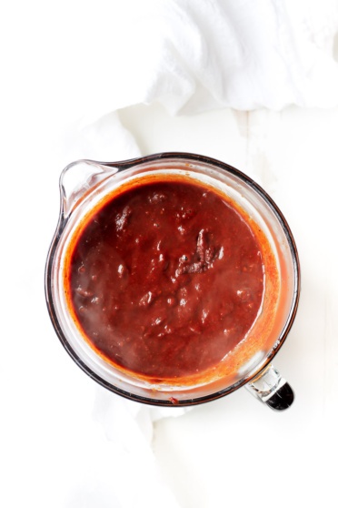 healthy Homemade Enchilada sauce in a glass measuring cup
