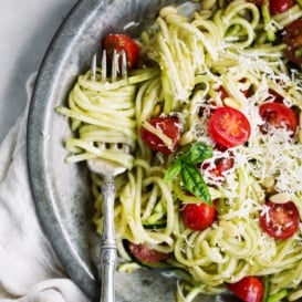 pesto zucchini noodles with tomatoes in a bowl