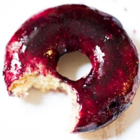 Almond Blueberry Glazed Donut with a bit taken out