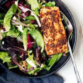 honey garlic salmon over a salad in a bowl