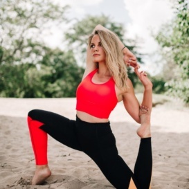 monique doing yoga in the sand