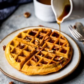 drizzling syrup on healthy pumpkin waffles
