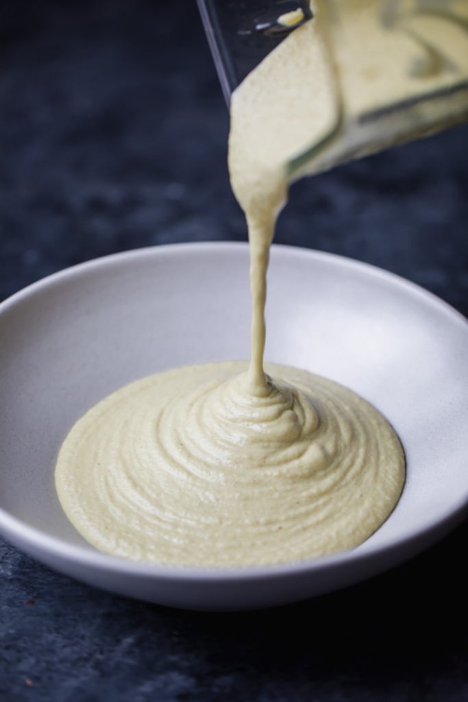 Learn how to make a delicious vegan cashew cheese sauce made with a few simple ingredients -- tastes just like a creamy nacho cheese sauce!