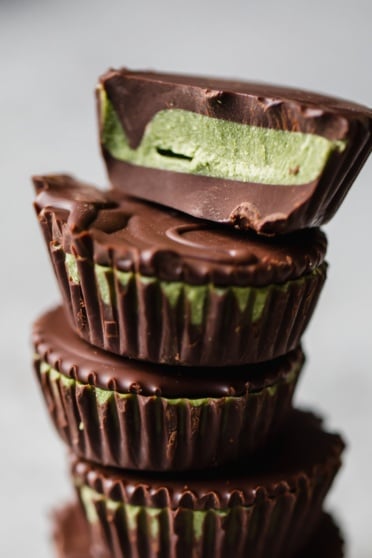 matcha dark chocolate coconut butter cups in a stack