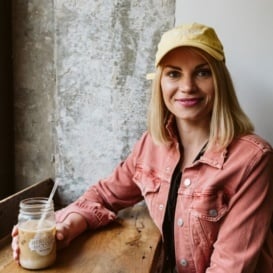 monique wearing a yellow hat sitting at a counter