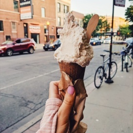 hand holding an ice cream cone in the air