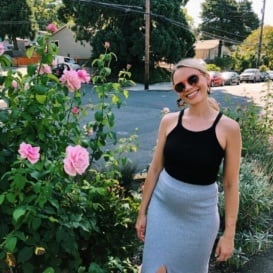 monique in front of a rose bush