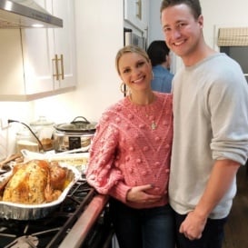 monique and tony in the kitchen in front of a thanksgiving turkey