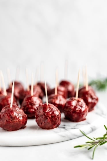 slow cooker bbq cranberry turkey meatballs on a platter with toothpicks